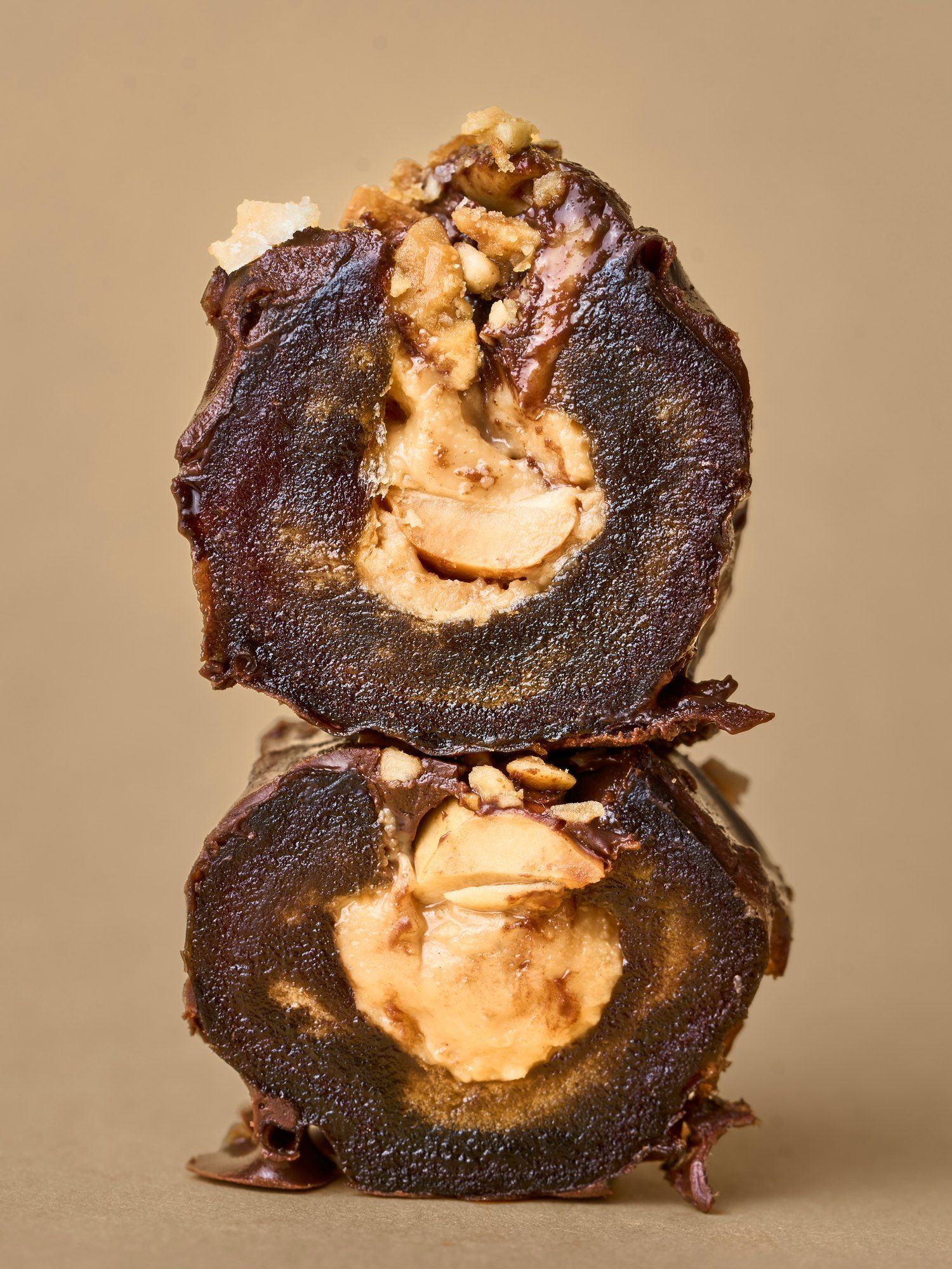 Two halves of a PITT Peanut date stacked, peanut butter inside
