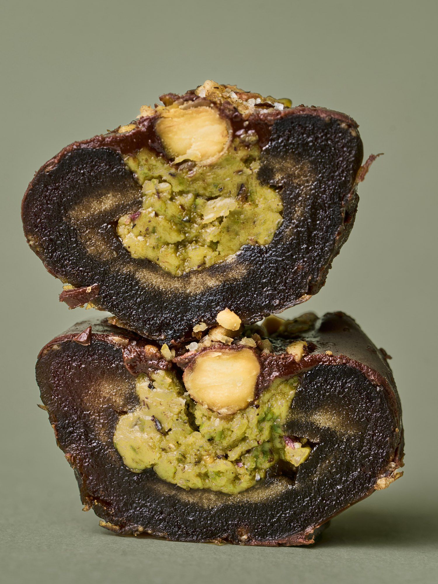 Two halves of a PITT Pistachio date stacked, pistachio paste inside